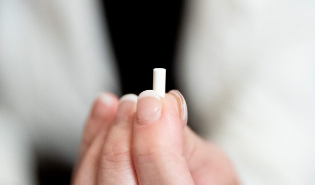 A close-up of a BioTE pellet, used for hormone optimization in wellness treatments.