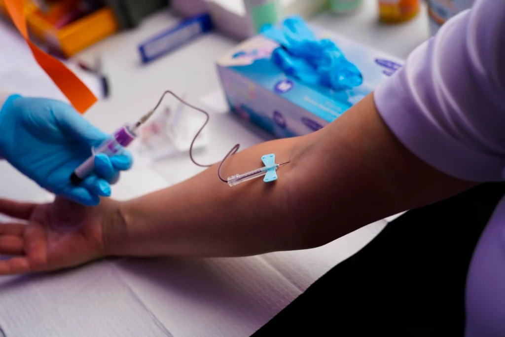 A nurse draws blood for lab work, a critical step in personalized wellness treatment.