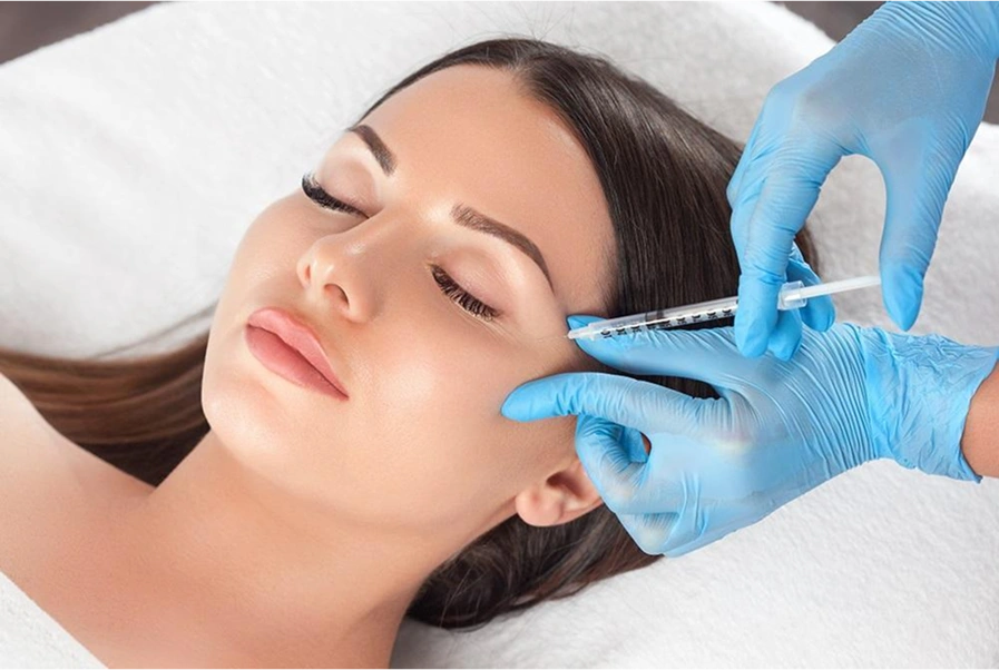 A woman receives a cosmetic injection, a medical procedure for enhancing beauty and skin wellness.